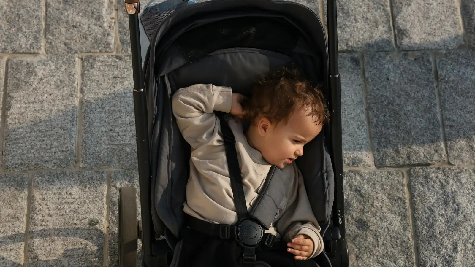 Infant car seat attached to a stroller frame